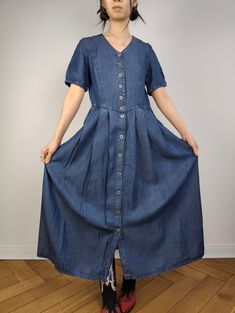 DESCRIPTION The Dark Blue Maxi Denim Shirt Dress is a beautiful vintage long dress in a soft dark denim fabric. CONDITION This dress is in great vintage condition SIZING This vintage dress is estimated as a size S > please check measurements below as all vintage sizes are different. Model is size XS and is 1m65 MEASUREMENTS  Arms till shoulder seam: 25cm Shoulder till shoulder seam: 38cm Armpit to armpit: 46cm Waist: 40cm Length: 126m MATERIAL 100% cotton  Light and smooth denim fabric BRAND Tencel WITH LOVE  All vintage fashion for women are washed/cared for and shipped from Berlin with a lot of love All vintage clothing are one of a kind and might have some small imperfections. The clear flaws will be written under condition. By Jenny from The Vintage Takeaway Summer Indigo Denim Dress With Buttons, Indigo Denim Short Sleeve Dress With Pockets, Indigo Denim Dress With Pockets And Short Sleeves, Dark Wash Short Sleeve Dress With Buttons, Dark Wash Short Sleeve Dress With Button Closure, Indigo Short Sleeve Denim Dress, Short Sleeve Washed Blue Dress With Buttons, Washed Blue Short Sleeve Dress With Buttons, Vintage Short Sleeve Denim Dress For Summer