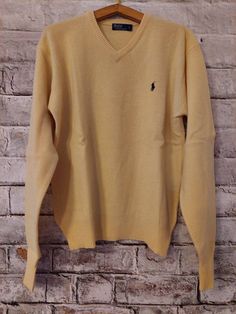 "Vintage POLO Ralph Lauren 90's Man Sweater, V neck, long sleeves, colour yellow, pure wool. The sweater fits an L size there is a small mending on the body, please check pictures Contact me for any questions or further pictures! 
R.C.CLO by Clotilde Capra is licensed under a Creative Commons Attribuzione - Non commerciale - Non opere derivate 3.0 Unported License. Follow us on Facebook! https://www.facebook.com/R.C.Clo Take a look at our blog: https://rcclo.wordpress.com Join us on Instagram: @ Classic Solid V-neck Long Sleeve Sweater, Casual Wool Polo Sweater With V-neck, Casual Wool V-neck Polo Sweater, Classic Yellow Sweater For Fall, Casual Yellow Wool Sweater, Yellow Long Sleeve Sweater, Yellow Wool Winter Sweater, Vintage Long Sleeve V-neck Sweater For Winter, Classic Long Sleeve V-neck Sweater For Fall