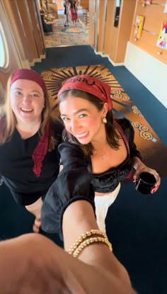 two women taking a selfie in front of the camera on a cruise ship with their arms around each other