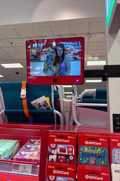 the television is on in the store and it's being watched by someone else