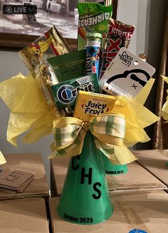 a green vase filled with candy and candies