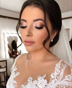 a woman wearing a wedding dress and makeup