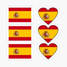 three heart shaped stickers with the flag of spain on one side and two hearts in the other