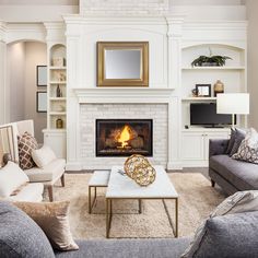 a living room filled with furniture and a fire place in the middle of a room