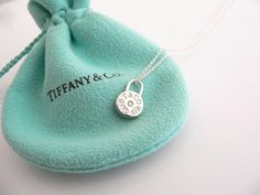 Overview:Everyone needs a signature Tiffany piece! Here is the perfect one just for you - and it is quite a rare and hard to find piece.   Offered for sale is a wonderful Tiffany & Co. Sterling Silver 1837 Diamond Circle necklace.  The piece is crafted from bright Tiffany silver, yet retains its feminine and delicate feel.  Hanging from its sterling silver Tiffany curb chain is a super pretty 1837 Circle pendant accented with a Diamond Center -  Just gorgeous!  It is a wonderful necklace t Infinity Chain Necklace Tiffany Co, Designer Engraved Necklace For Gift, Diamond Necklace Pendant, Diamond Circle Necklace, Tiffany And Co Necklace, Tiffany Necklace, Round Necklace, Circle Diamond, Gift Love