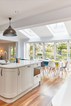 an open kitchen and dining room with skylights