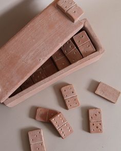 a wooden box filled with dominos on top of a table