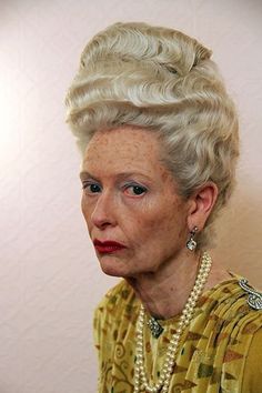 an older woman with white hair and pearls