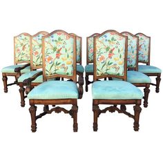 six chairs with blue upholstered back and floral designs on the backs, set of four