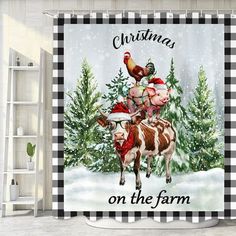 a christmas themed shower curtain with a cow and chicken on it's back in the snow