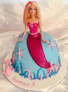 a barbie doll cake with pink and blue frosting