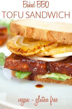 a sandwich with meat, lettuce and cheese on it sitting on a plate