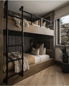 the bunk beds are made from wood and have metal bars on each side, along with pillows