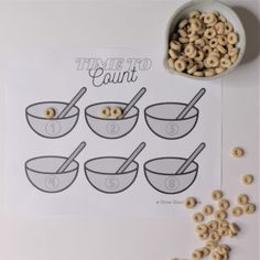 cereals are being made in bowls with spoons and measuring tape on the table