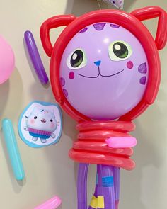 an assortment of children's toys on a white table with pink and purple items