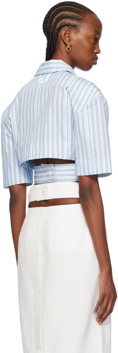 Cotton poplin shirt. Jacquard logo pattern and stripes throughout. · Spread collar · Concealed button closure · Patch pocket · Cutouts at waist · Integrated adjustable button belt at cropped hem · Dropped shoulders · Locker loop at back collar · Logo-engraved hardware Part of the Les Sculptures collection. Supplier color: Print blue stripe Designer Button-up Tops For Summer, Modern Fitted Tops With Striped Collar, Modern Fitted Top With Striped Collar, Summer Office Shirt With Striped Collar, Fitted Tops With Striped Collar For Daywear, Blue Striped Shirt, Bra Style, Cotton Poplin Shirt, Logo Pattern