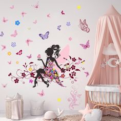 a child's room with butterflies and a fairy wall decal on the wall