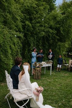 the bride and groom are sitting on their lawn chairs