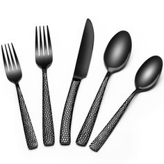 five spoons, two forks and one knife on a white surface with an intricate pattern