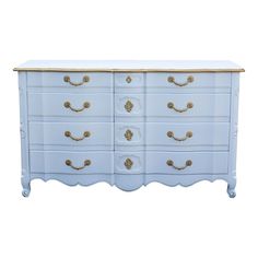 a white dresser with gold handles on it's top and bottom drawers, against a white background