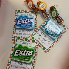 some candy bar wrappers are sitting on top of a table with other items around them