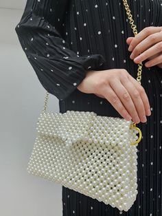 ✨ Introducing our Pearl Beaded Handbag ✨ Get ready to turn heads with this stunning pearl beaded handbag! Perfect for adding a touch of elegance to any outfit, this bag is made with high-quality faux pearls that give it a luxurious look and feel. The gold chain strap adds a chic touch, making it versatile enough for both day and night outings. Whether you're heading to a wedding, a dinner party, or just a casual day out, this bag is your go-to accessory. This handbag is crafted with high-quality faux pearls, offering an elegant gold chain strap that complements its luxurious look. The design is versatile, making it perfect for any occasion, and it's the ideal size to carry all your essentials. Elevate your style with this must-have accessory! Pearl White Rectangular Pearl Clutch, Rectangular Pearl White Pearl Clutch, Pearl Embellished Clutch Shoulder Bag, Cream Beaded Pearl Shoulder Bag, Pearl Beaded Bag, Hand Beaded Bag, Bridal Purse, Crystal Bags, Beaded Bag