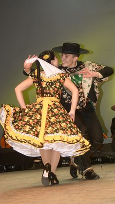 a man and woman dancing on stage together