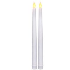 two white candles sitting side by side