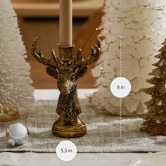 a table topped with christmas trees and candles