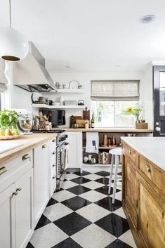 a black and white checkered floor in a kitchen with lots of counter top space