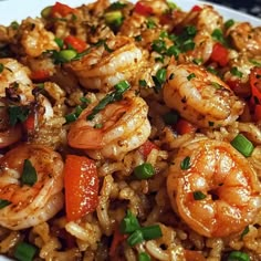 a white plate topped with rice and shrimp