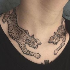 black and white photo of two cheetah tattoo on woman's upper neck