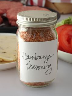 a jar filled with food sitting on top of a table next to a plate of meat