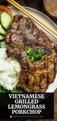 a plate with meat, rice and cucumbers on it next to chopsticks