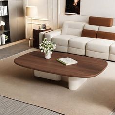 a modern living room with white and brown furniture