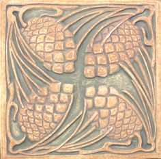 an intricately designed tile in the shape of a cross with leaves and flowers on it