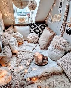 a room filled with lots of pillows and blankets