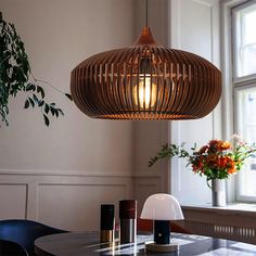 a dining room table with a lamp hanging over it