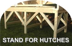 the stand for hutches is made out of wood and sits in the grass outside