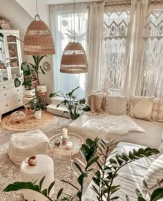 a living room filled with lots of furniture and plants