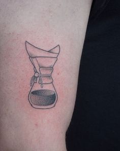 a black and white photo of a coffee pot tattoo