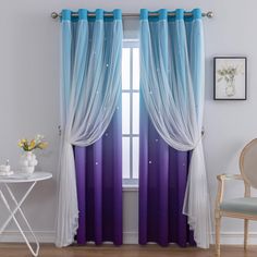 blue and purple curtains hanging in front of a window with white drapes on it