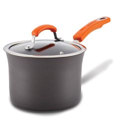 an orange handle is on the lid of a pot with a black bottom and gray base