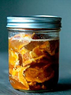 a jar filled with food sitting on top of a wooden table