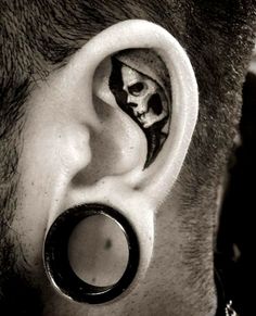 a man with a fake skull in the middle of his ear is wearing a black and white photo