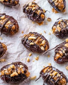 chocolate covered donuts with nuts and chopped walnuts on top, ready to be eaten