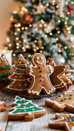 several decorated cookies on a table next to a christmas tree