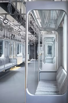 the interior of a train car with mirrors reflecting it's doors and windows on both sides