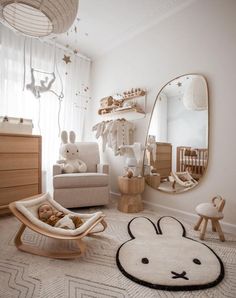 a baby's room with an animal rug, rocking chair and teddy bear bed