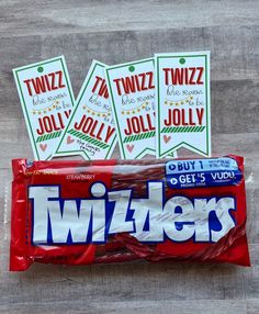 three twizzlers candy bars sitting on top of a wooden table next to each other